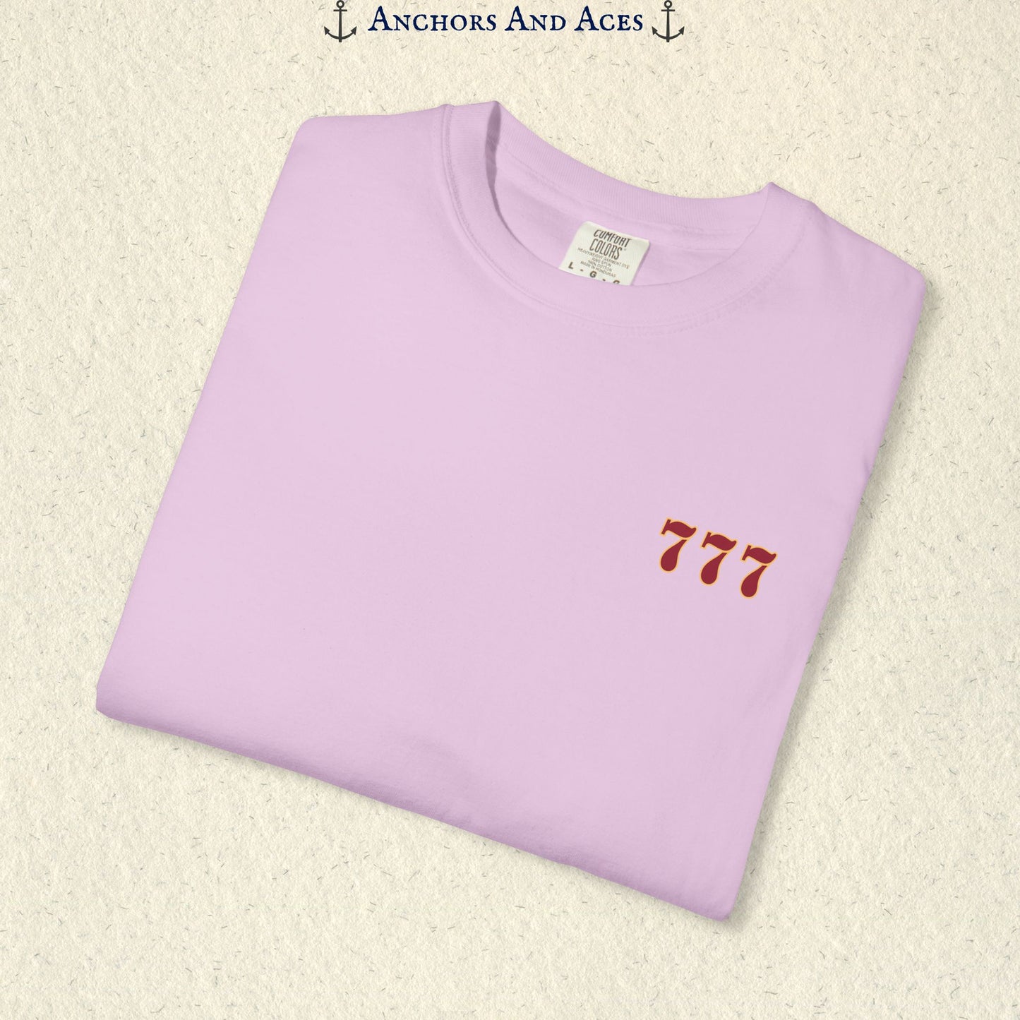 Folded Orchid Lucky 777s T-shirt showing the small red 777 casino emblem on the front chest.