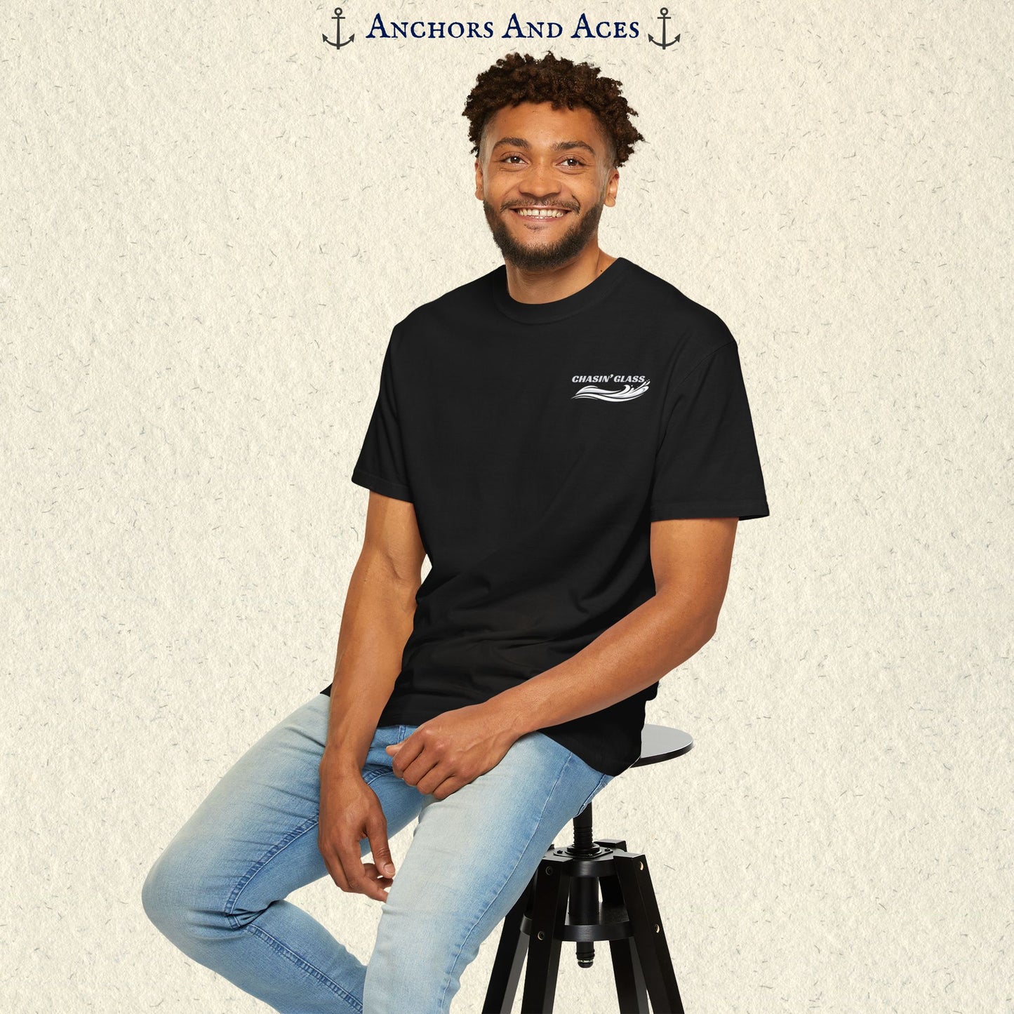 Model wearing a black vintage water ski T-shirt, front view, with the small white Chasin' Glass text and stylized water splash logo on the left chest.
