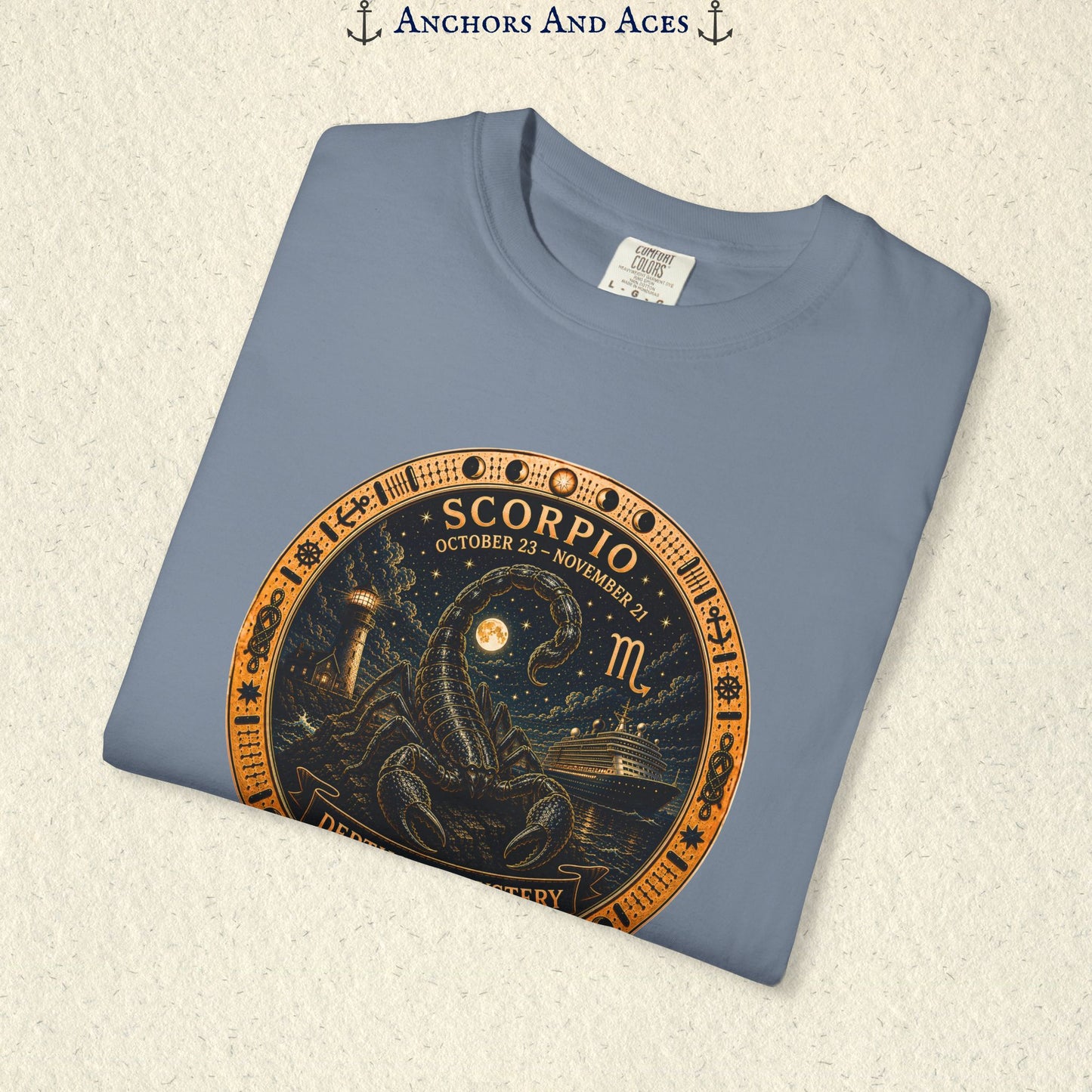 Folded Scorpio zodiac shirt close-up showing scorpion celestial medallion and Depths of Mystery artwork