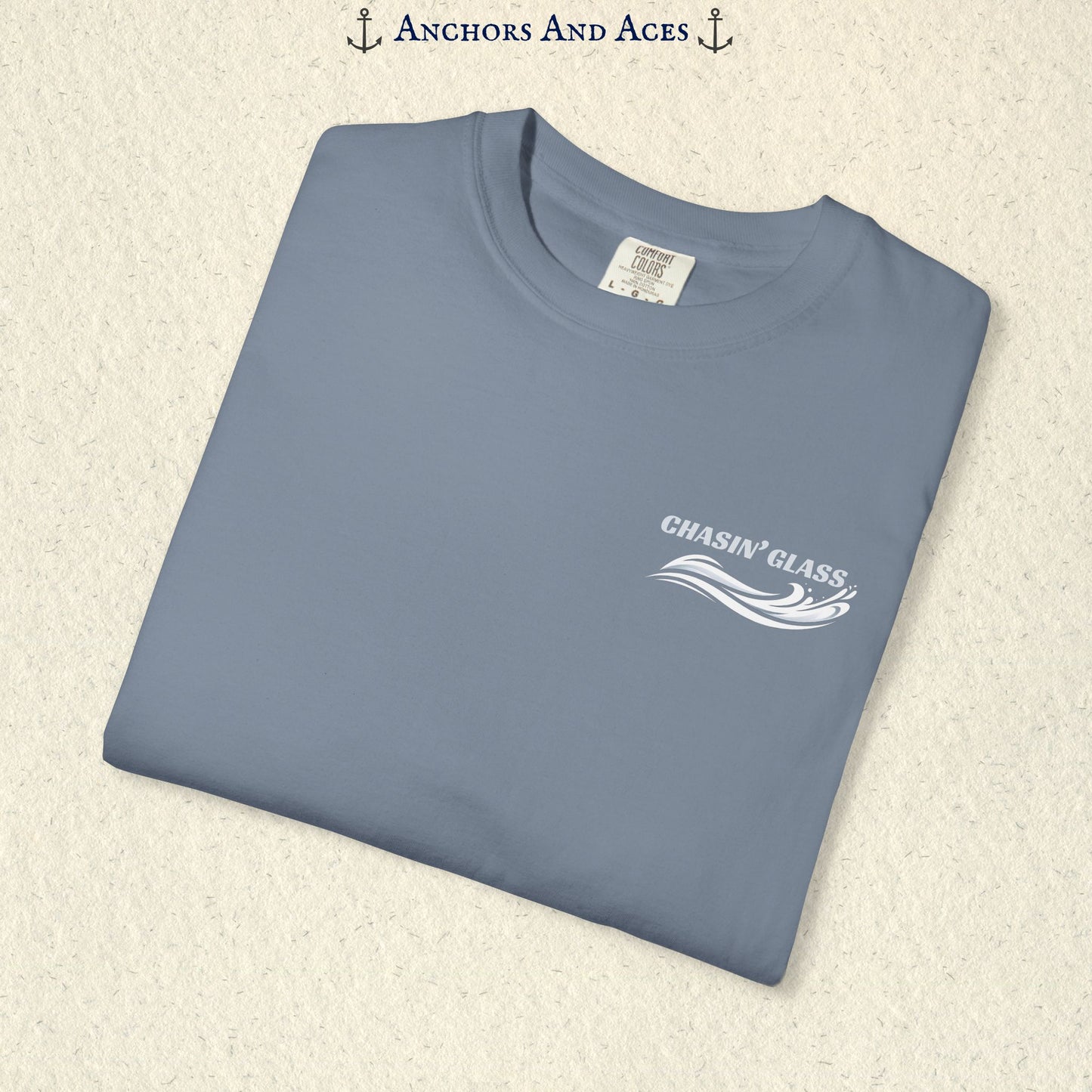Folded Blue Jean blue T-shirt showing the small white Chasin' Glass text and stylized water splash logo on the left chest.