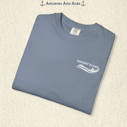 Folded Blue Jean blue T-shirt showing the small white Chasin' Glass text and stylized water splash logo on the left chest.
