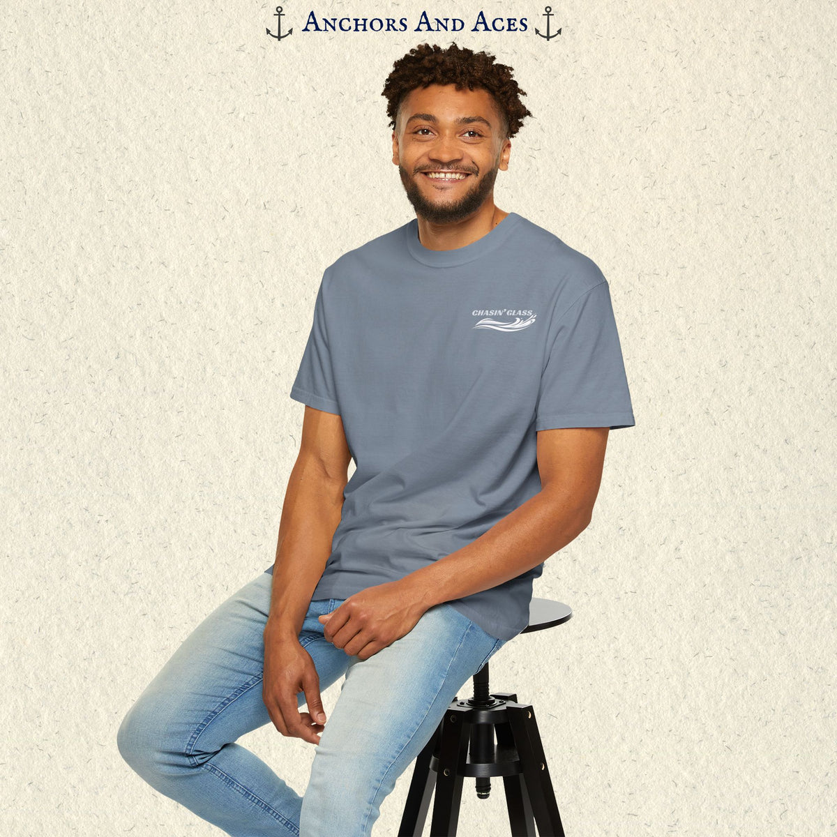Model wearing a Navy T-shirt from the front, showing the small white Chasin' Glass water splash logo on the left chest.