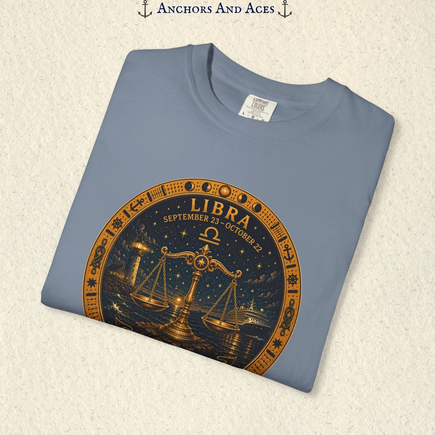 Folded Libra Zodiac Shirt close-up showing the balance scales celestial medallion front graphic.