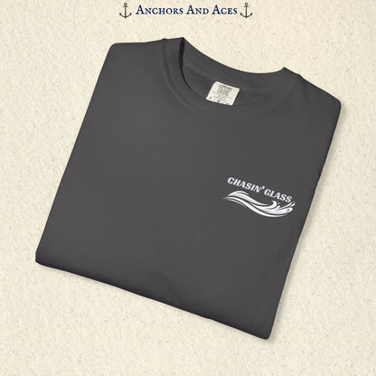 Folded Graphite gray T-shirt showing the small white Chasin' Glass text and stylized water splash logo on the left chest.
