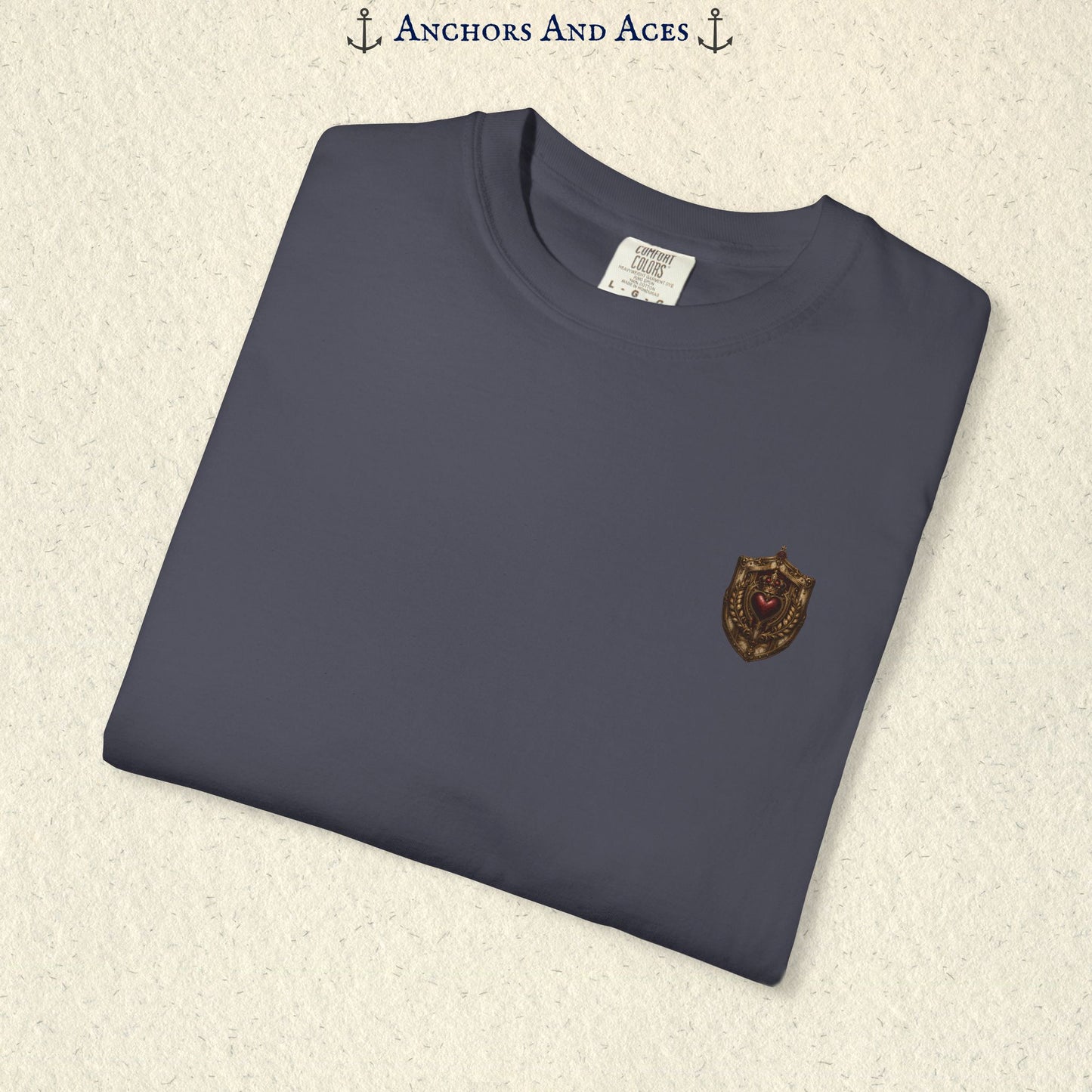 Folded House of Hearts graphic tee showing the small heraldic crest emblem on the front chest.