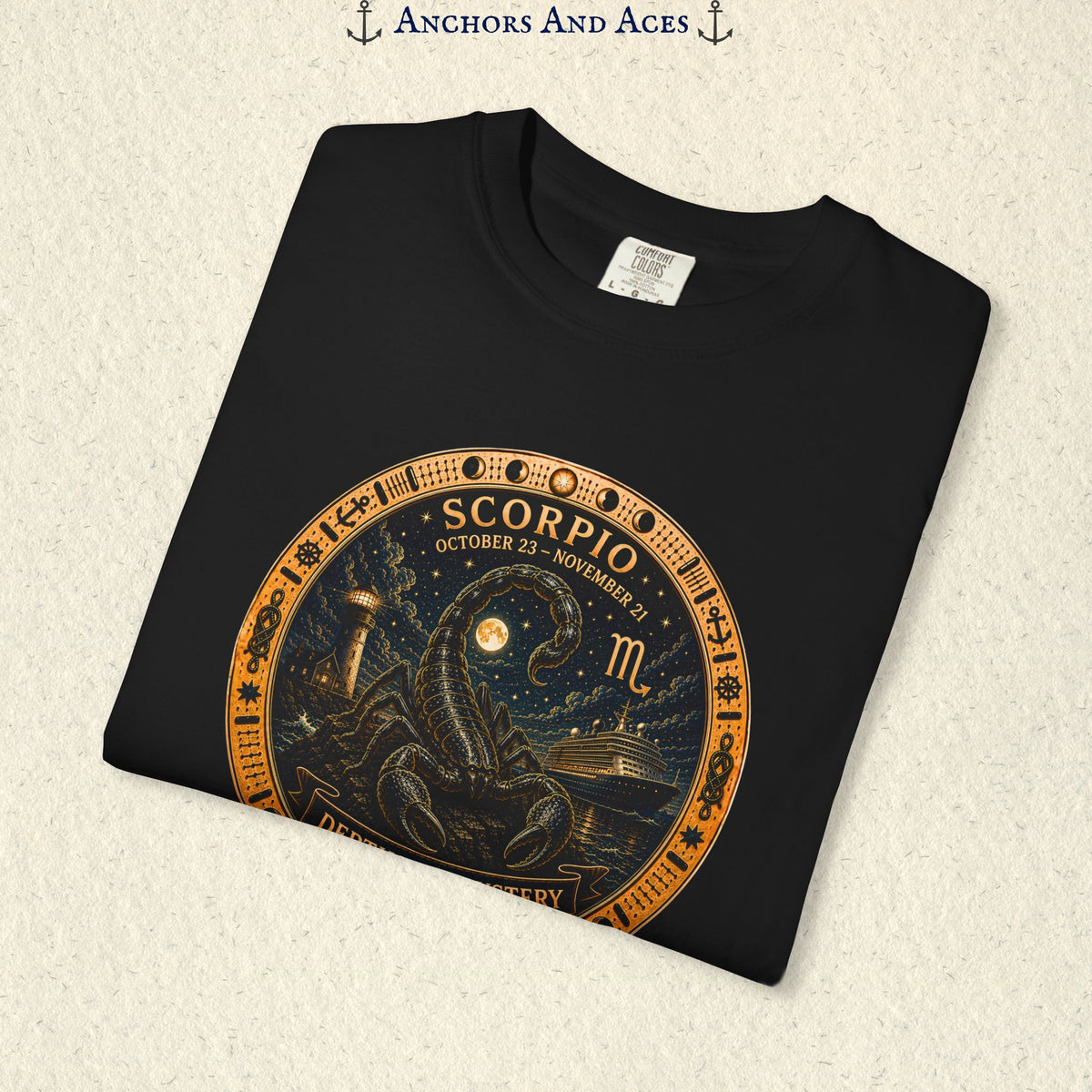 Folded Scorpio zodiac shirt close-up showing scorpion celestial medallion and Depths of Mystery artwork