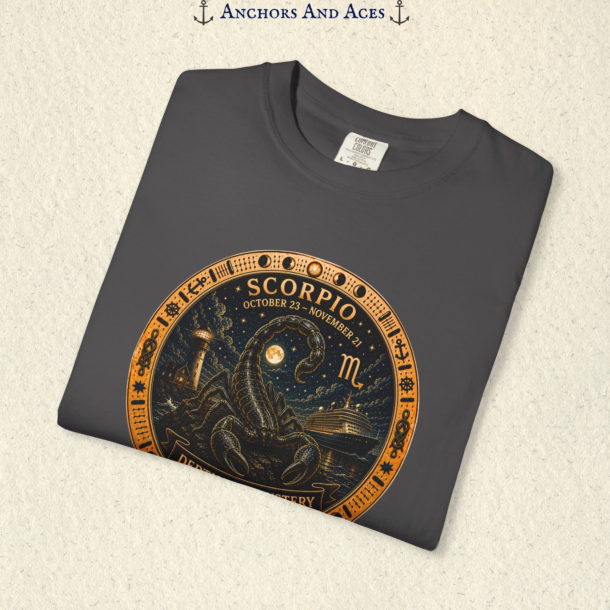 Folded Scorpio zodiac shirt close-up showing scorpion celestial medallion and Depths of Mystery artwork