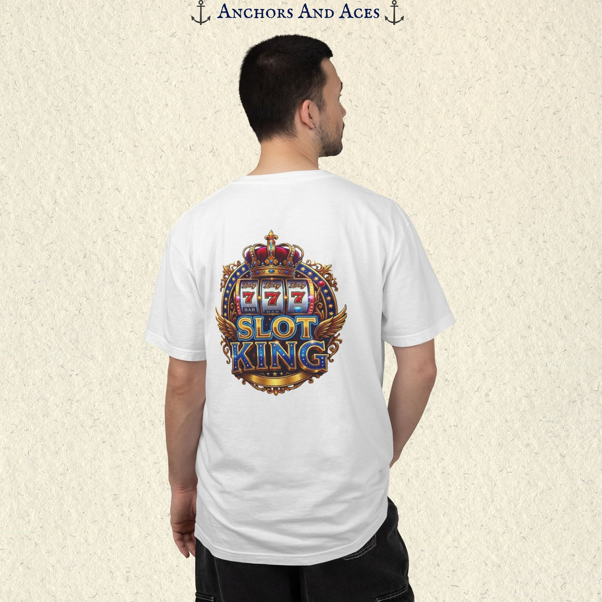 Man wearing a White Slot King T-shirt with the crowned 777 slot machine artwork on the back.